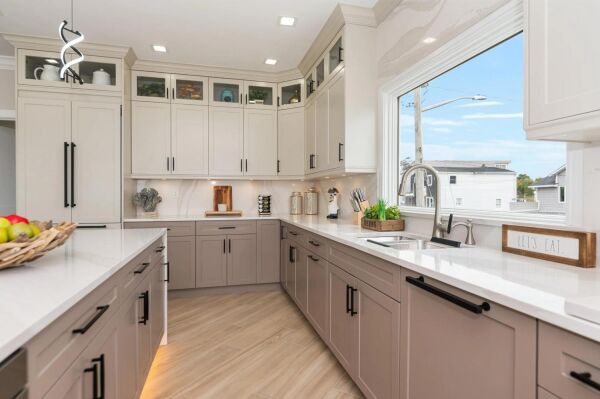 Modern Long Island kitchen remodel featuring sleek cabinetry, spacious countertops, and bright natural light from large windows, highlighting contemporary design elements for a culinary oasis.