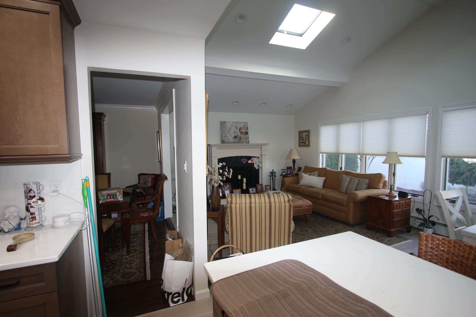 View from the kitchen peninsula across to the family room, with a skylight in the vaulted ceiling