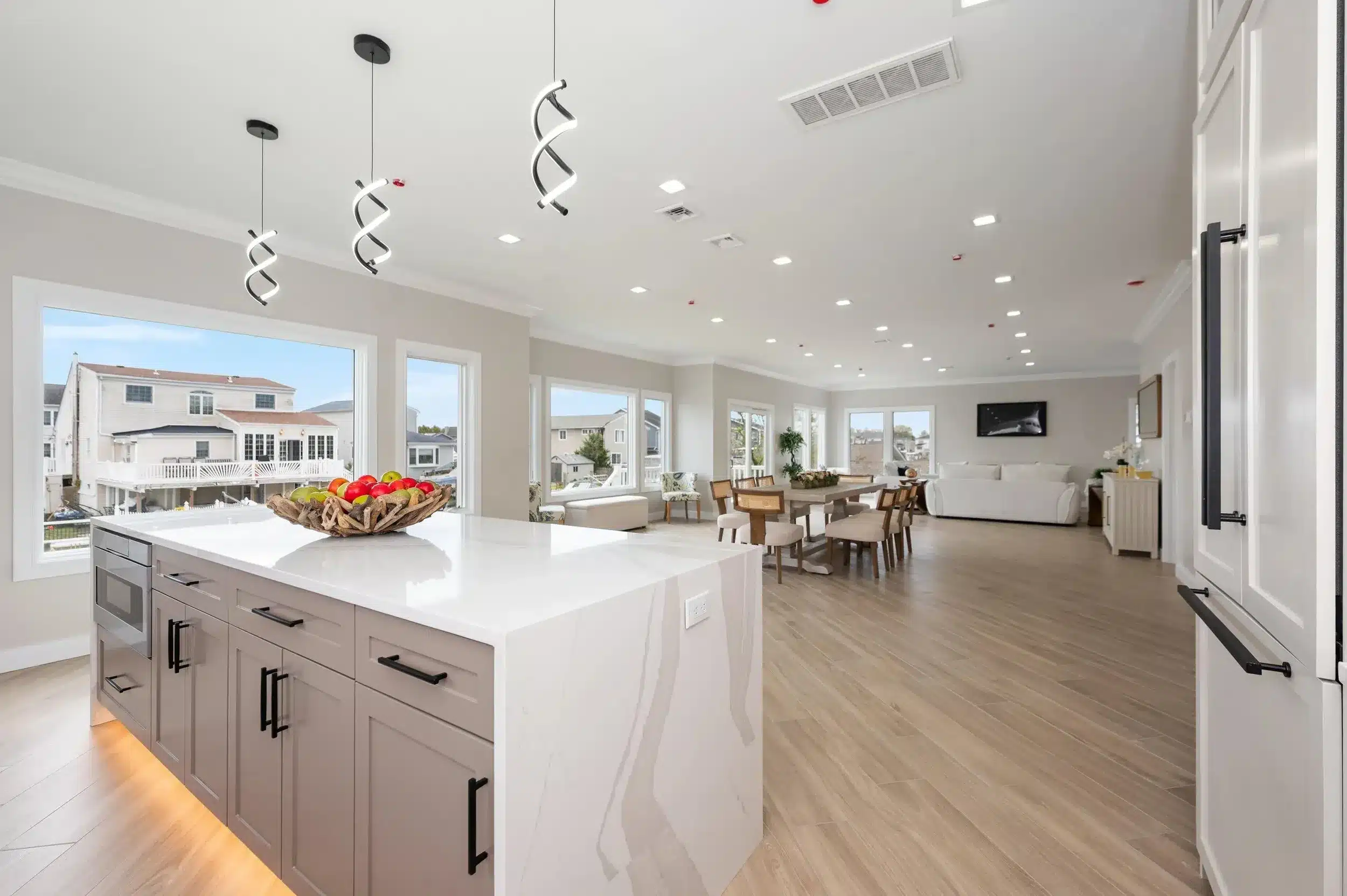 Modern open-concept kitchen and living area with a large island and dining space